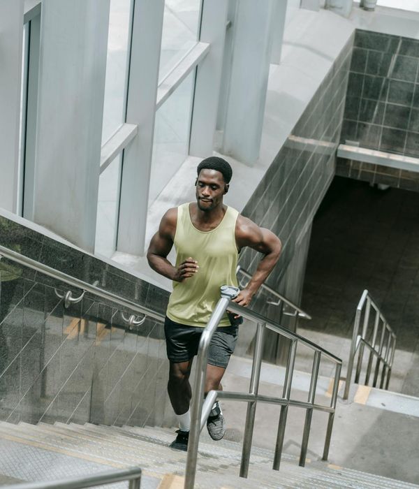 Man performing a strength exercise with focused determination in a modern gym.